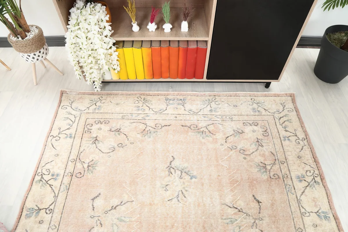 Angled view from above, focusing on the top portion of the rug and its interaction with room elements.