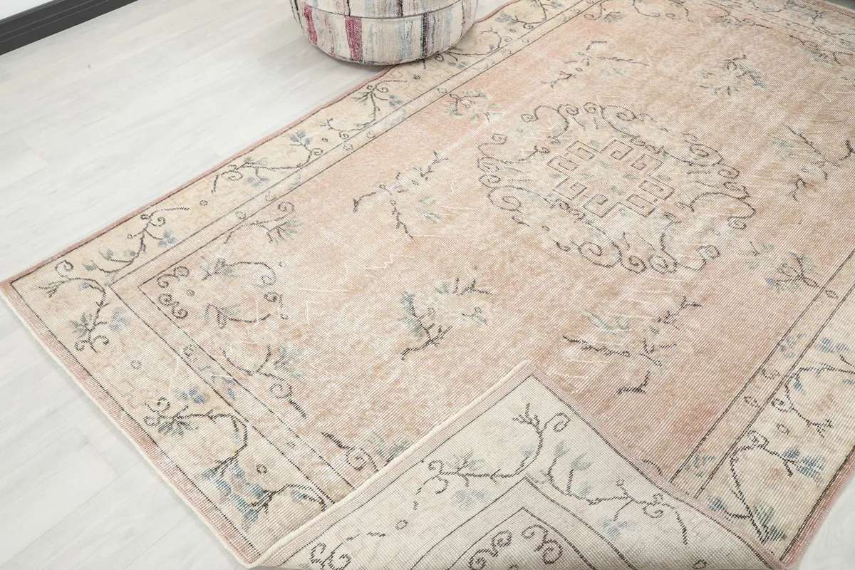 Angled view showing a portion of the rug folded back, revealing the reverse side and construction.