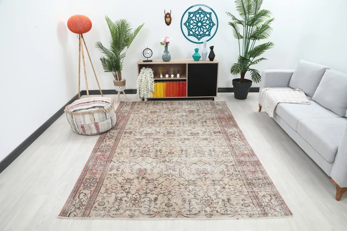 Vintage Anatolian rug displayed in a living room setting with a light gray sofa