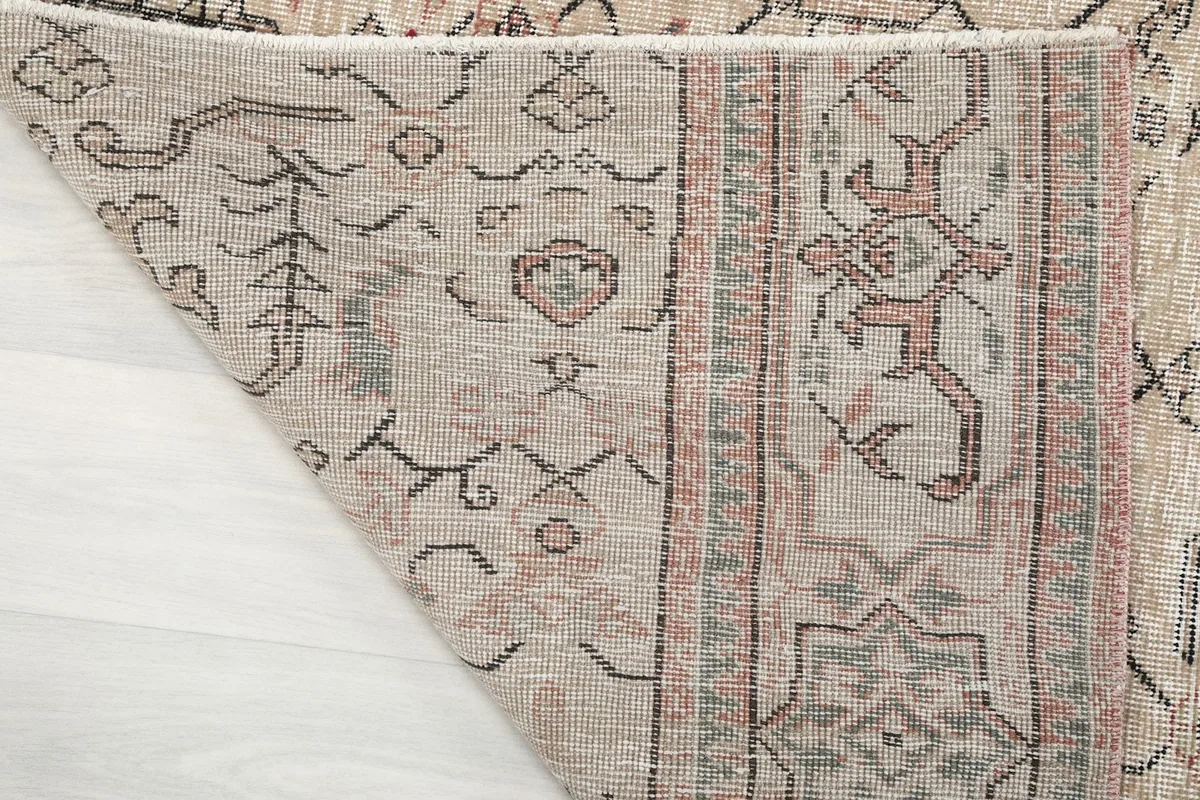 Underside view of the hand-knotted rug showing the tight weave of the cotton foundation