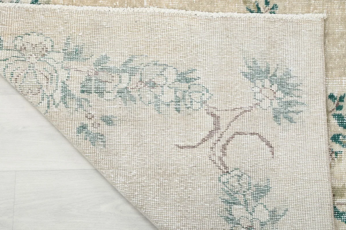 Close-up of the rug's back, revealing the hand-knotted structure and the design on the reverse.