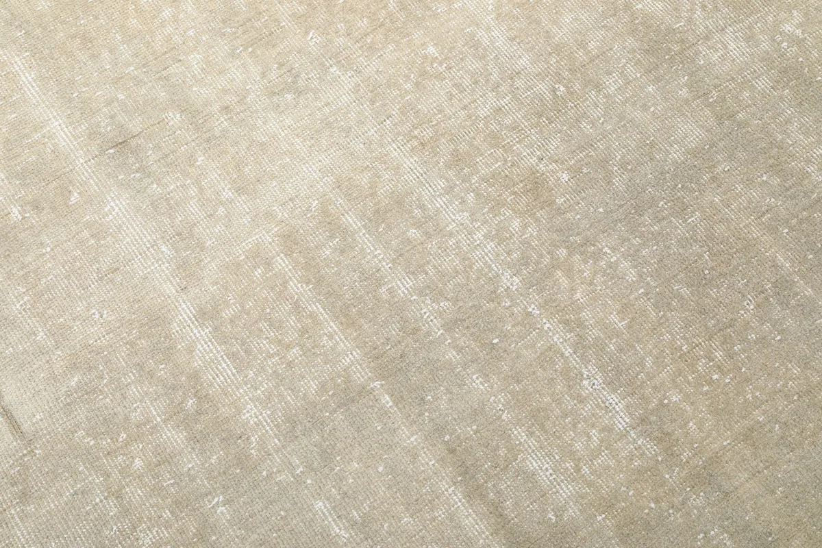 Close-up detail of the hand-knotted wool pile, showing its low height and texture.