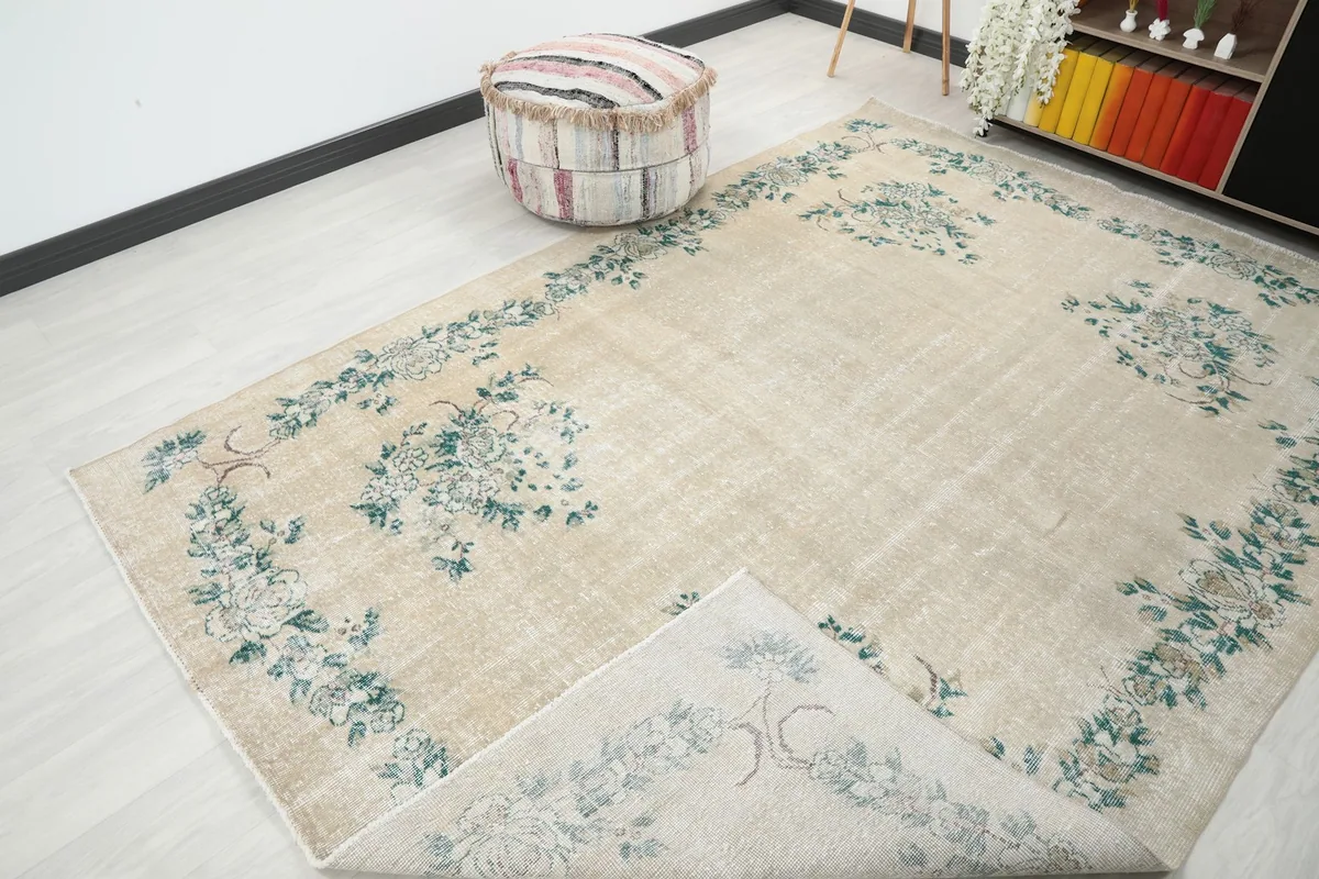 View of the rug with a corner folded back, showing the cotton foundation and reverse side of the knots.