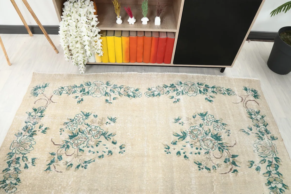 Direct overhead view of the rug within a room, showcasing the full floral design and ivory color.