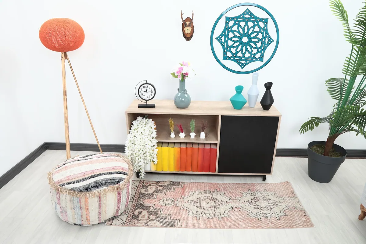 Runner rug in a room setting, showing its placement in front of a console table with decor