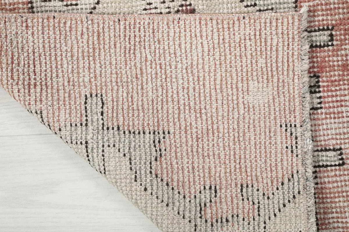 Underside view of the hand-knotted cotton foundation and wool knots