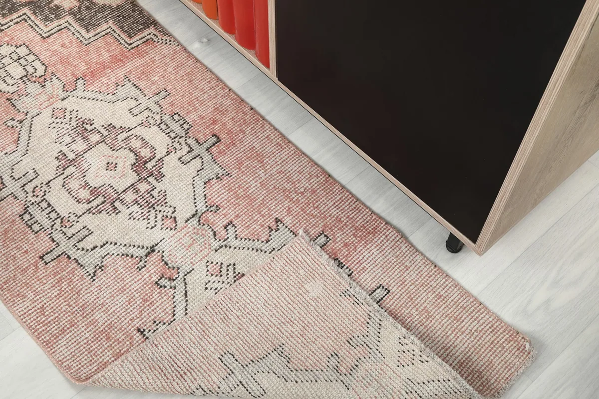 Corner of the runner rug folded to show the thickness and construction of the piece