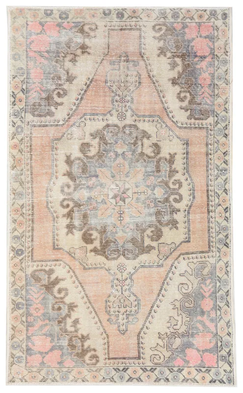 Full top view of the vintage Anatolian area rug with a rose and gray medallion pattern on a white background.