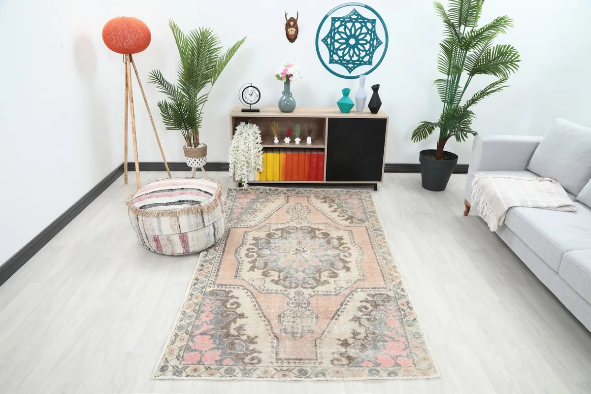 Vintage Anatolian rug displayed in a living room setting, showing its scale with furniture.