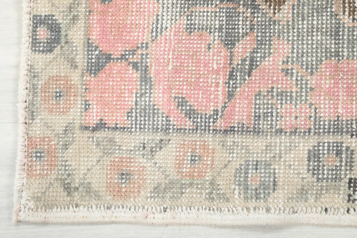 Detail of the rug's border design and fringe, showcasing the intricate patterns.