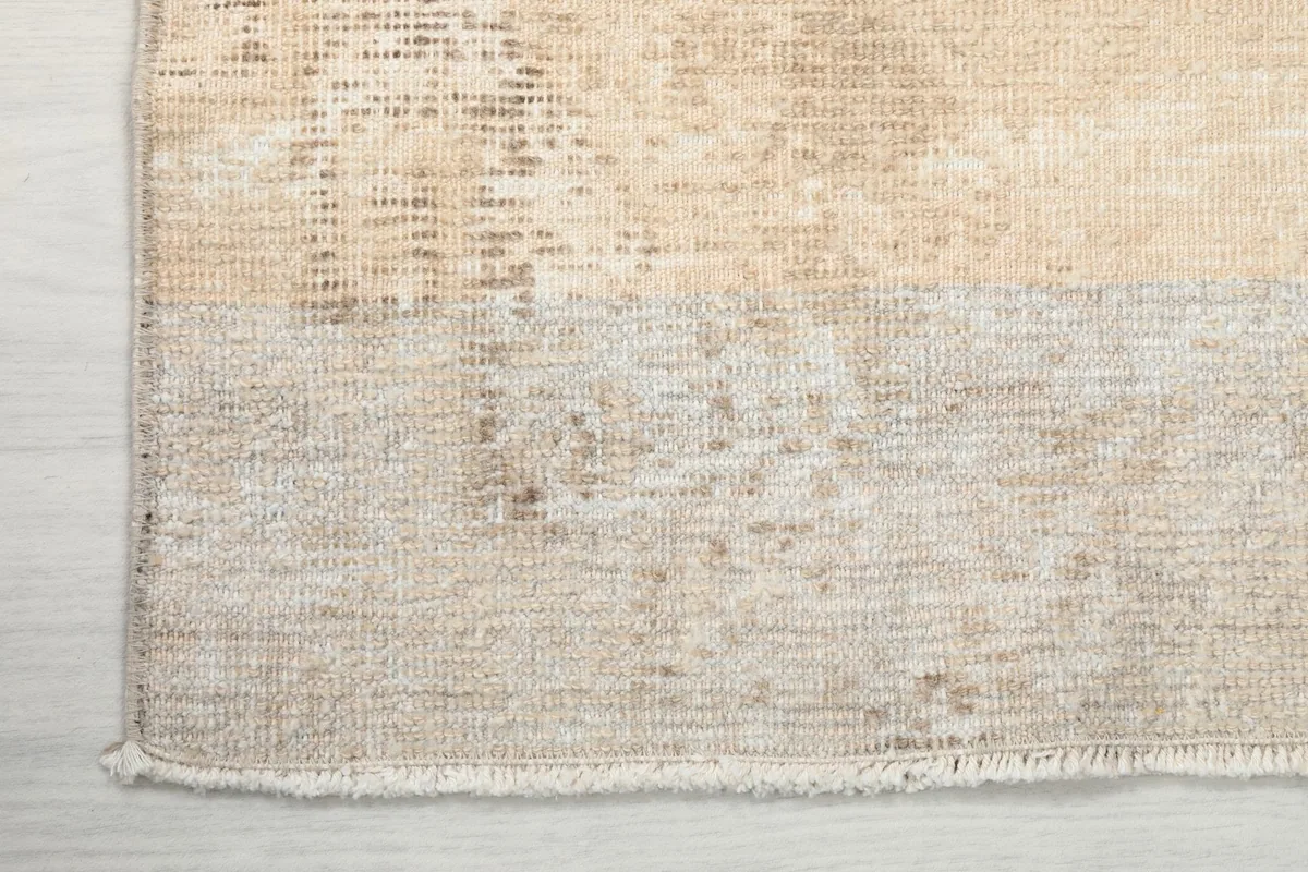 Corner detail of the rug, showing the edge finish and the transition of the pile.