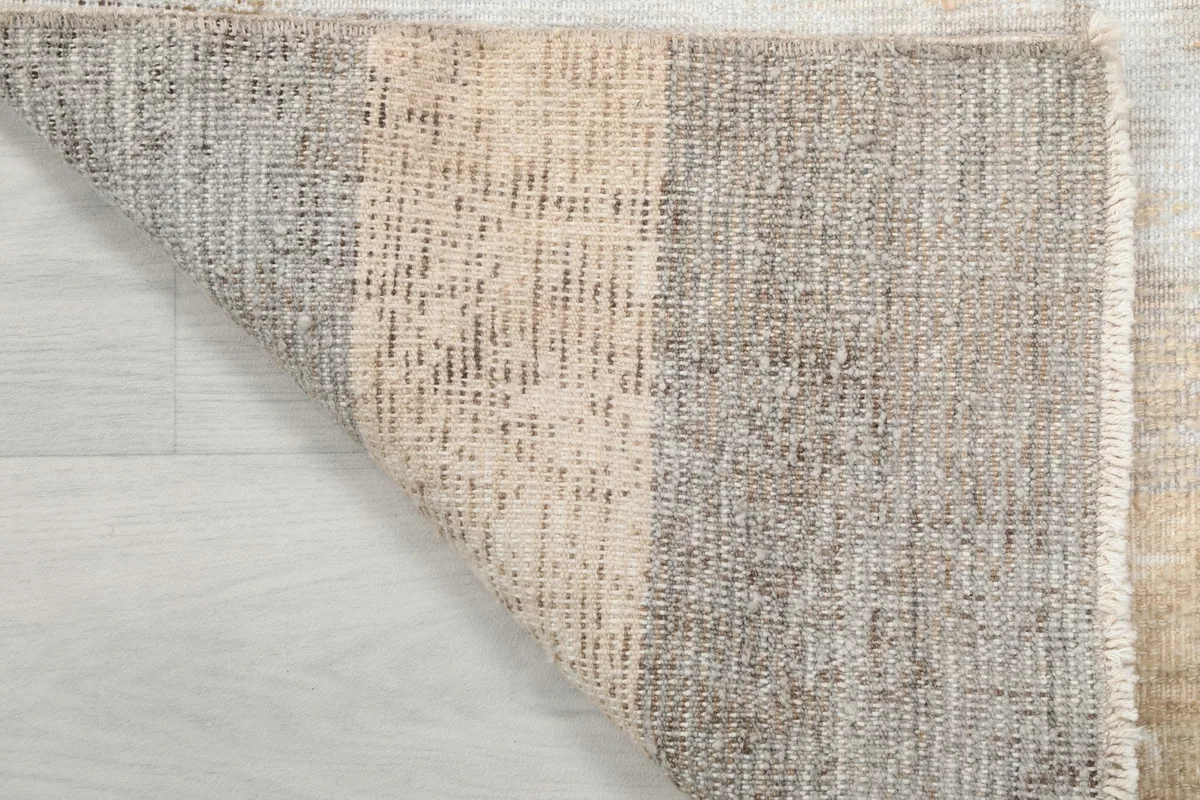 Close-up of the back of the rug, showing the cotton foundation and knotting detail.