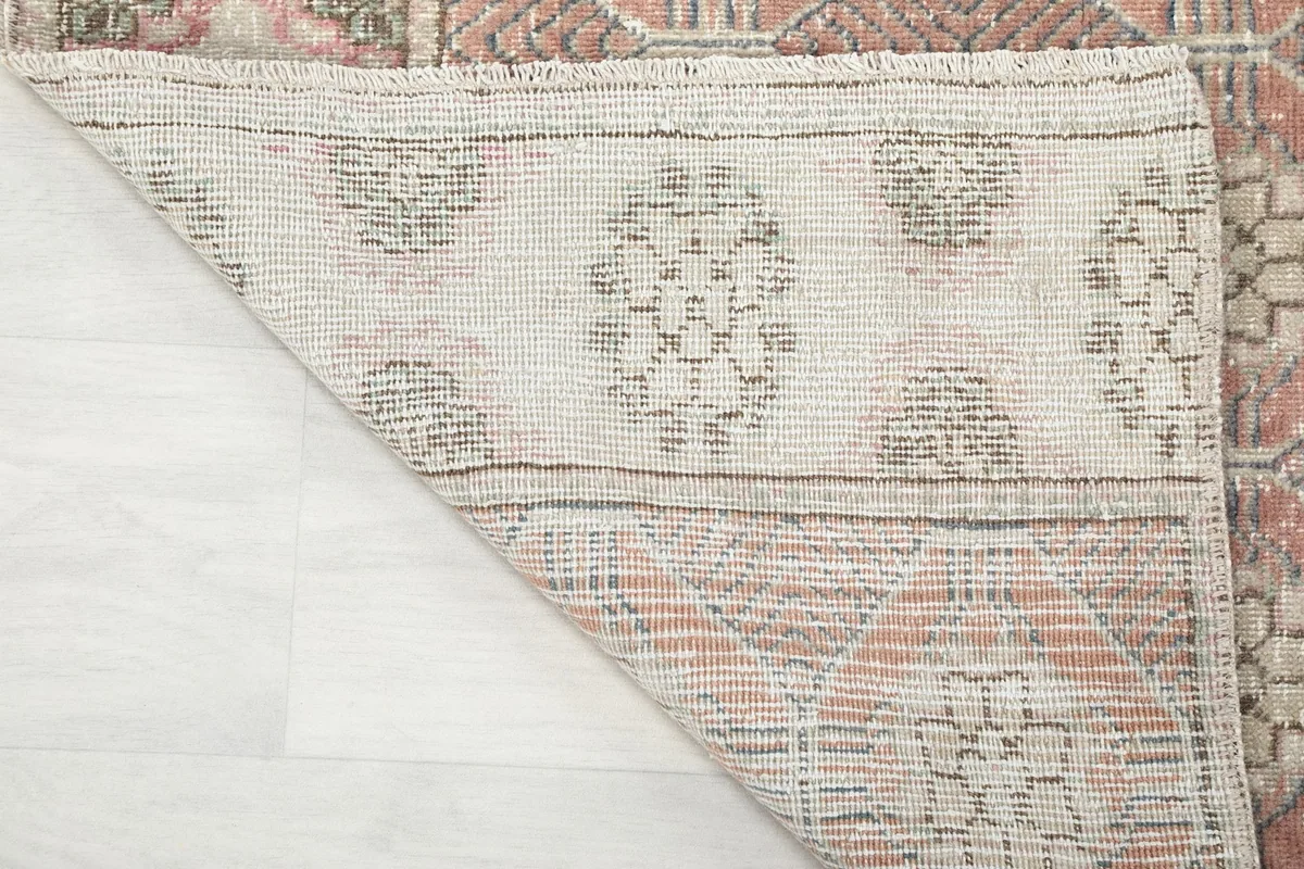 Reverse side of the vintage runner rug, showing the cotton foundation and knotting detail.