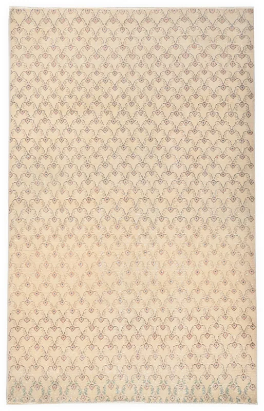 Full top view of the 4'4" x 6'11" beige and rose vintage Anatolian area rug on a white background.