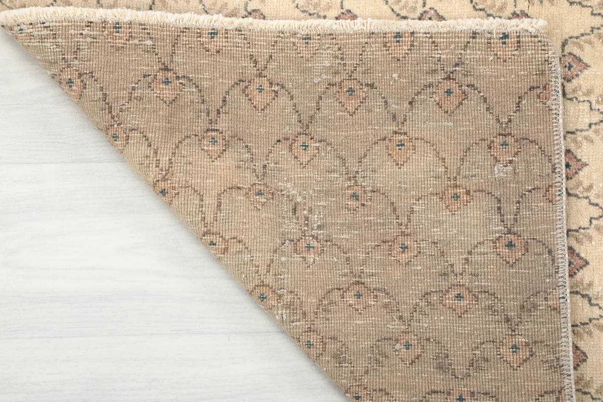 Corner lifted to show the reverse side of the hand-knotted Anatolian rug, displaying the knot work.