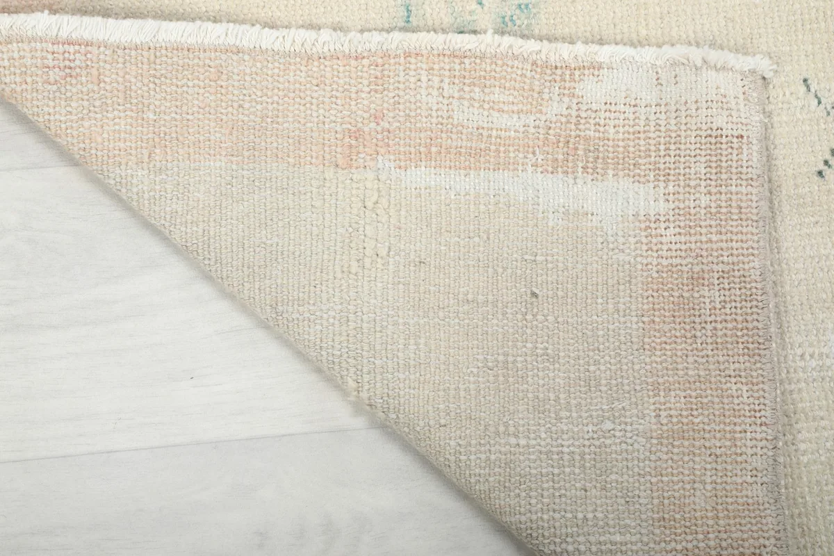 Close-up of the back of the hand-knotted runner rug, showcasing the tight weave of the cotton foundation.
