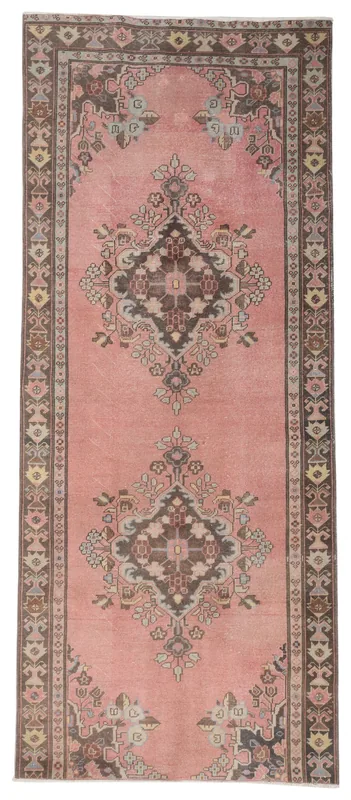 Full overhead view of the rose vintage Anatolian runner rug with tribal medallions
