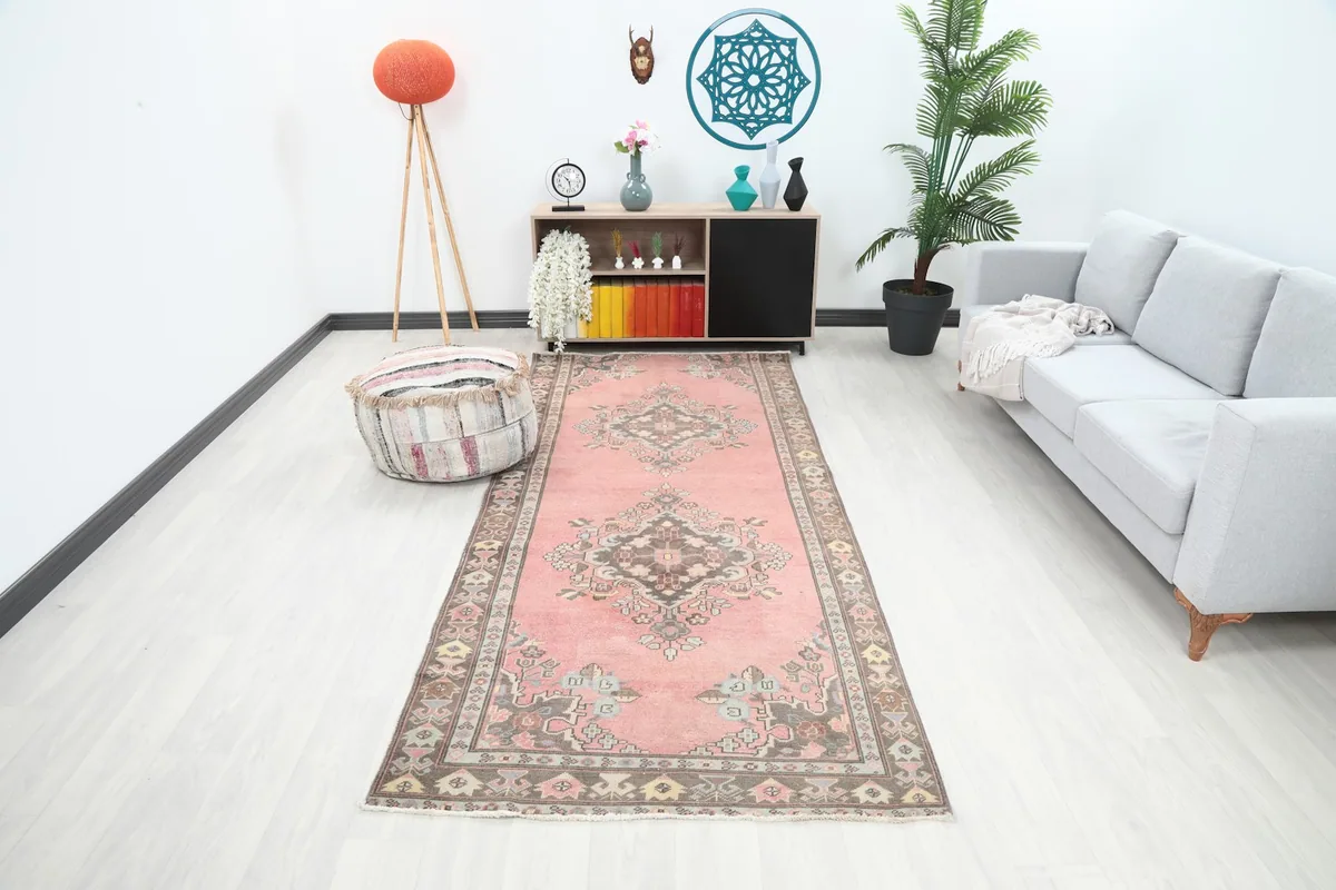 Vintage rose runner rug in a modern living space with a gray sofa and plant