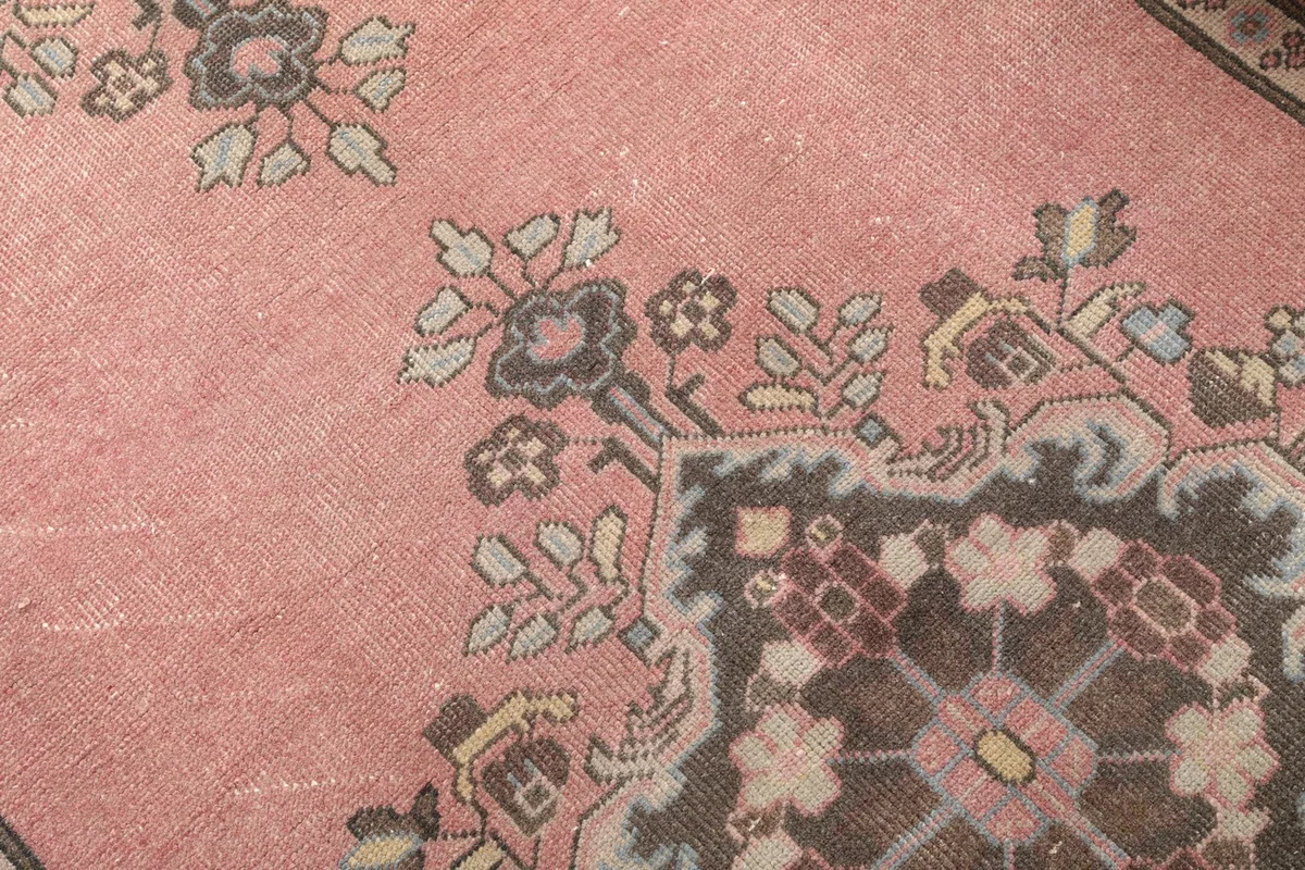 Detailed view of the rose field and a corner of a central medallion with subtle blue accents