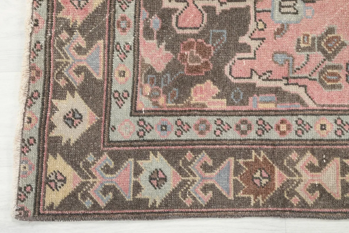 Close-up of the geometric border design in brown, beige, and blue tones