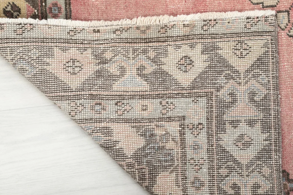 Detailed corner view of the rug's back, revealing the hand-knotted construction