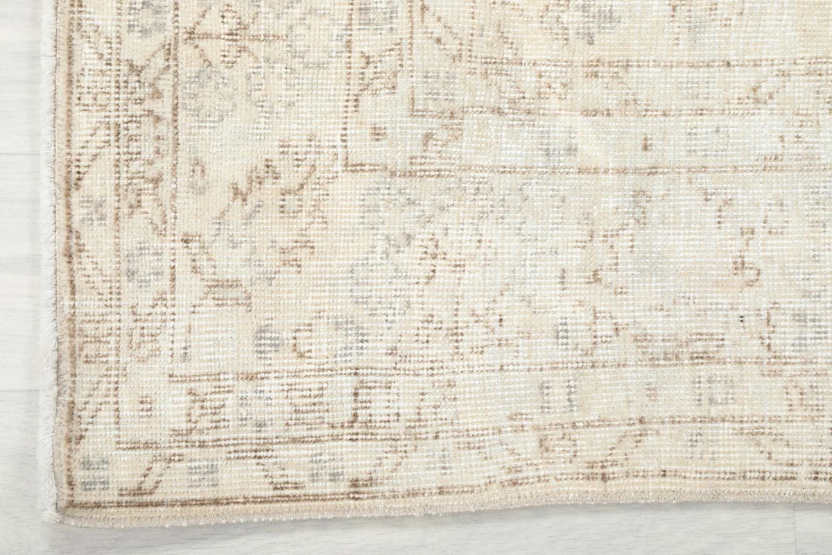 Detail of the rug's border, showing the traditional pattern and the edge finishing.