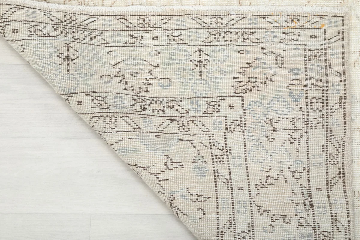 Close-up of the rug's underside, displaying the hand-knotted construction and cotton foundation.