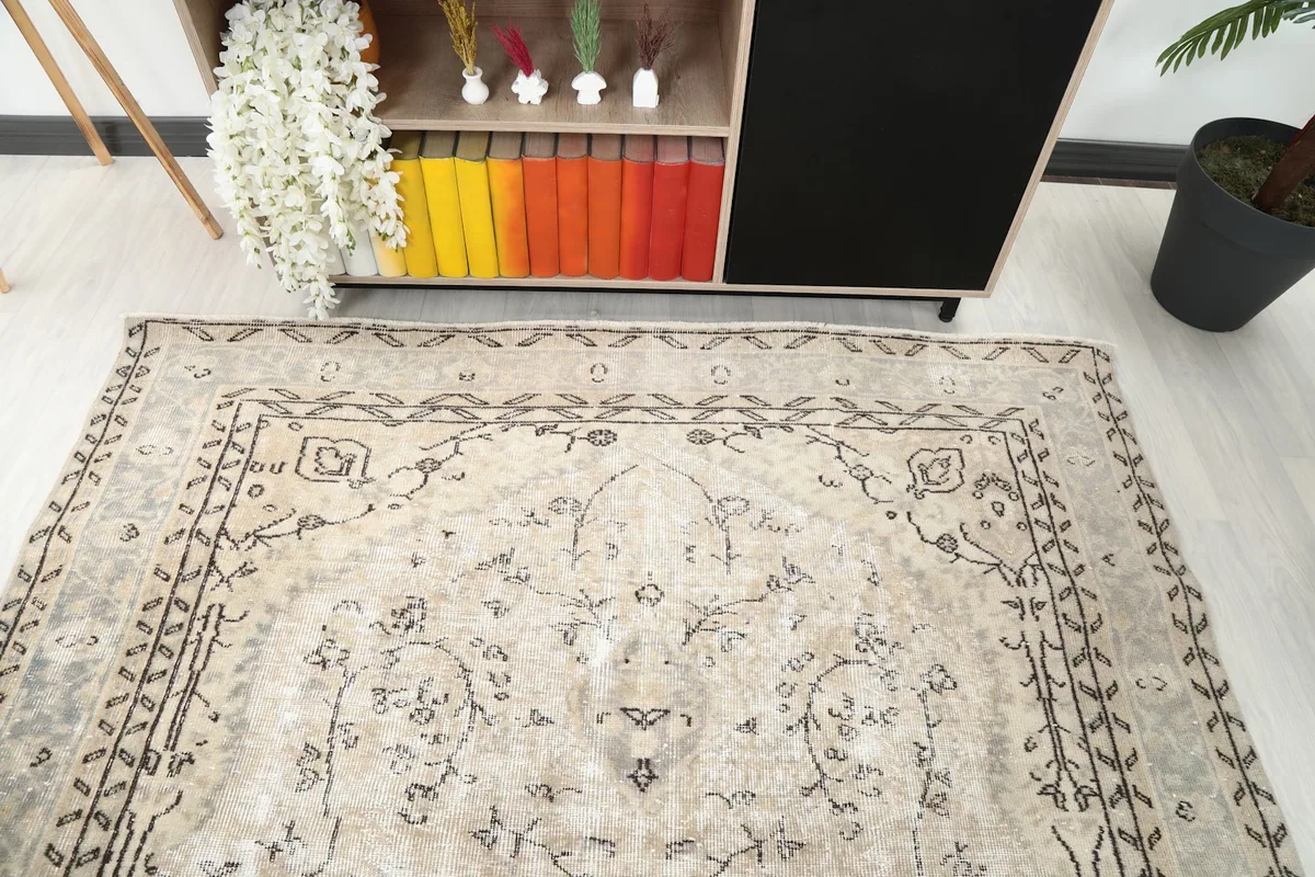 Detailed angle shot of the rug's upper section, revealing the border and field patterns.