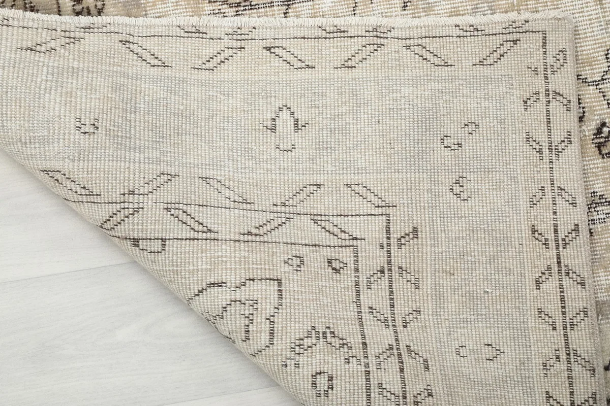 Close-up of the rug's underside, revealing the hand-knotted cotton foundation.
