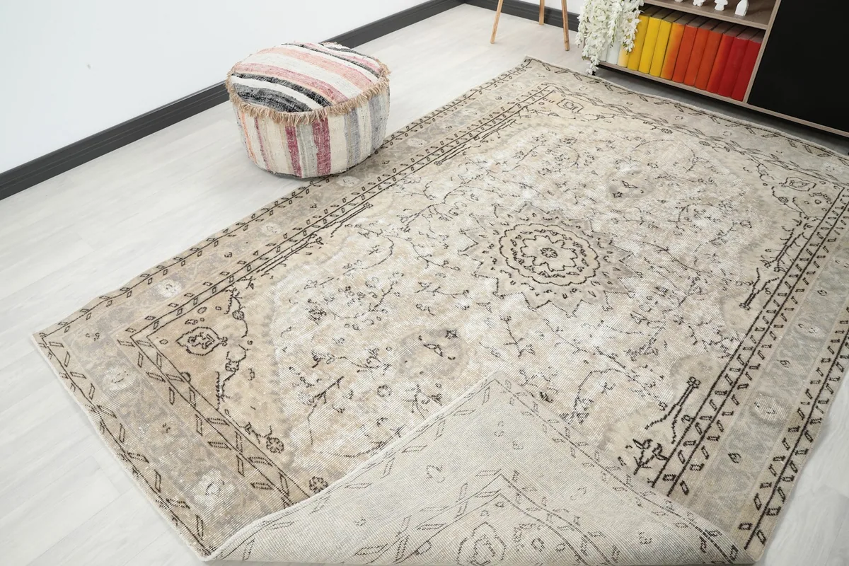 View of the rug with a corner folded back, showing the cotton foundation and pile.