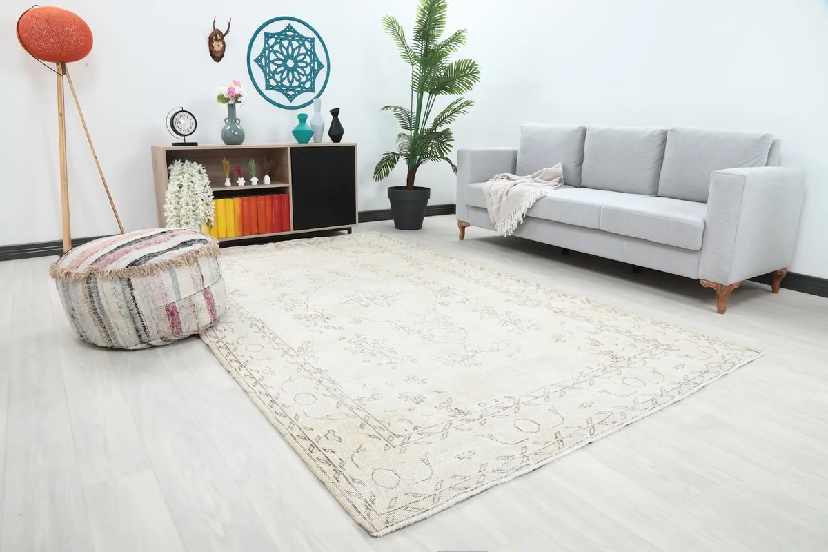 Angled view of the ivory area rug in a living space, highlighting its placement and design