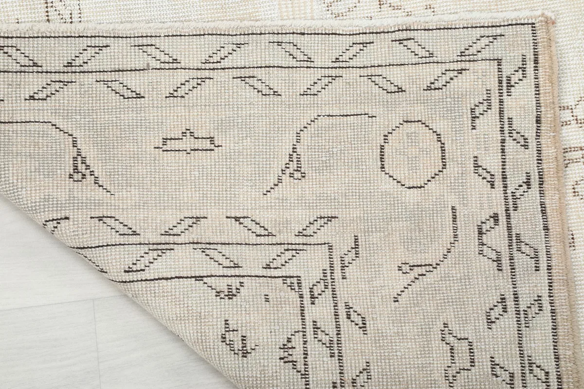 Underside view of the rug, revealing the hand-knotted cotton foundation and knotting detail