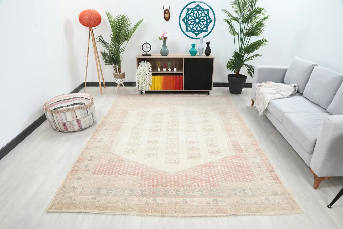 Vintage Anatolian rug displayed in a living room setting with a light gray sofa