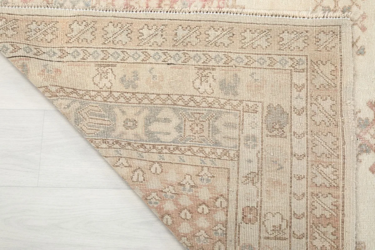 View of the rug's reverse side, showing the hand-knotted construction and cotton foundation