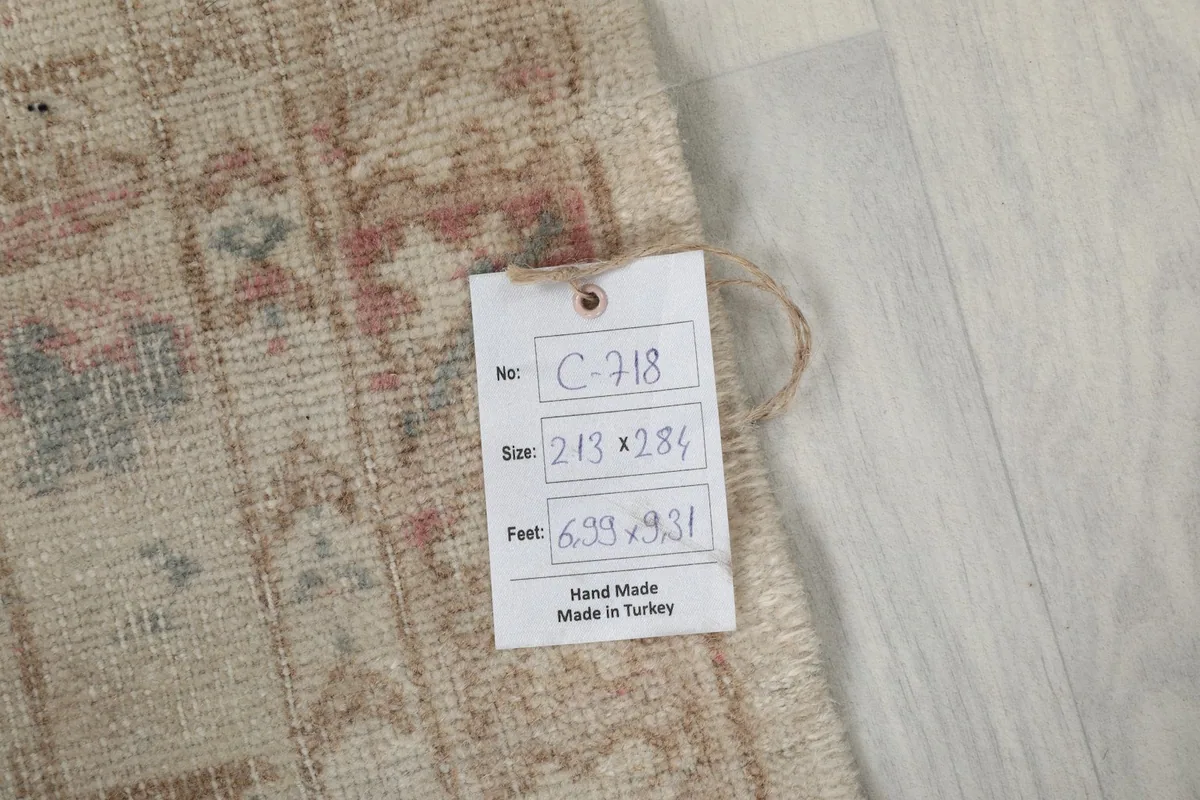 Close-up of the product tag displaying the rug's dimensions and origin