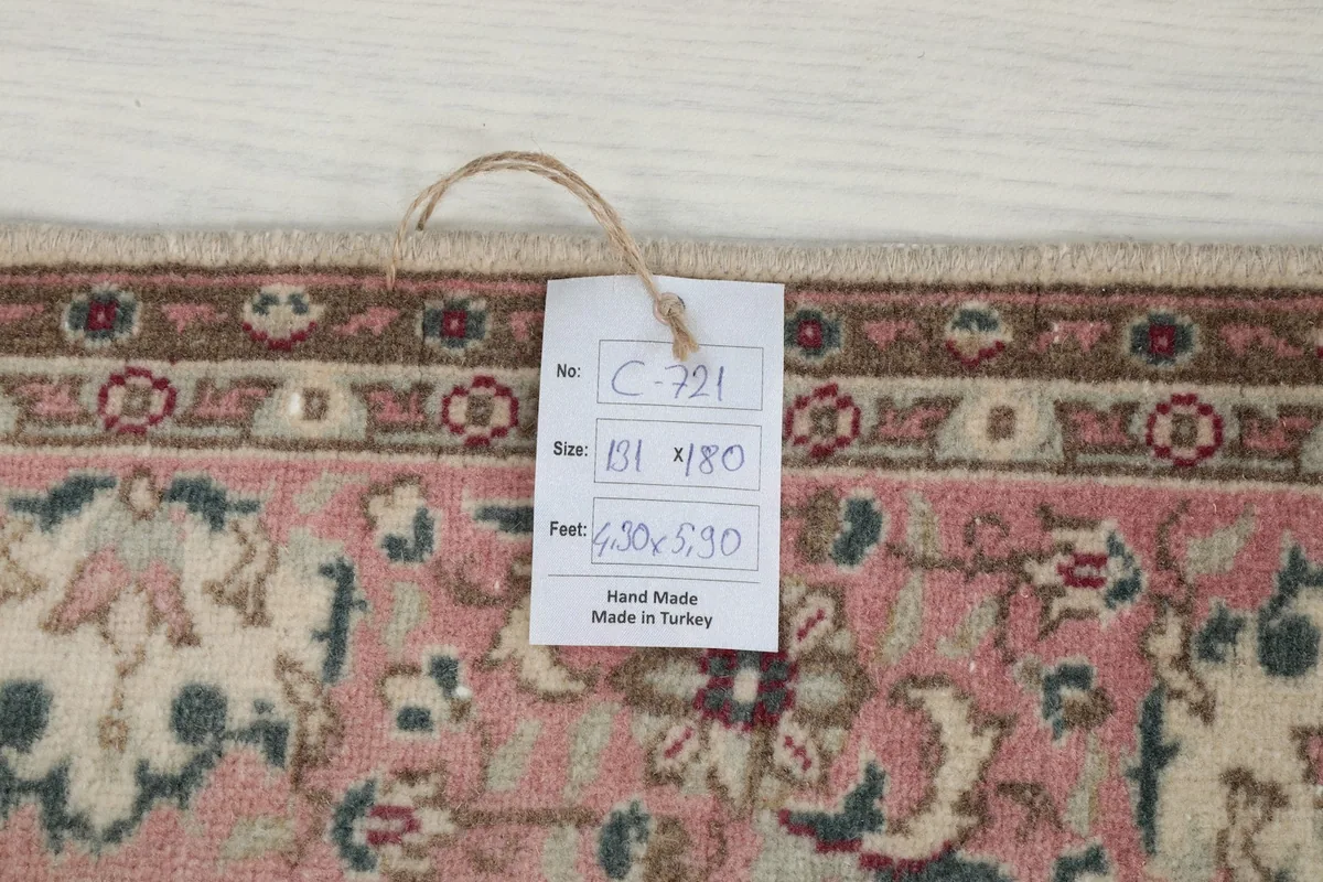 Product tag showing rug details and 'Hand Made in Turkey' on the reverse side