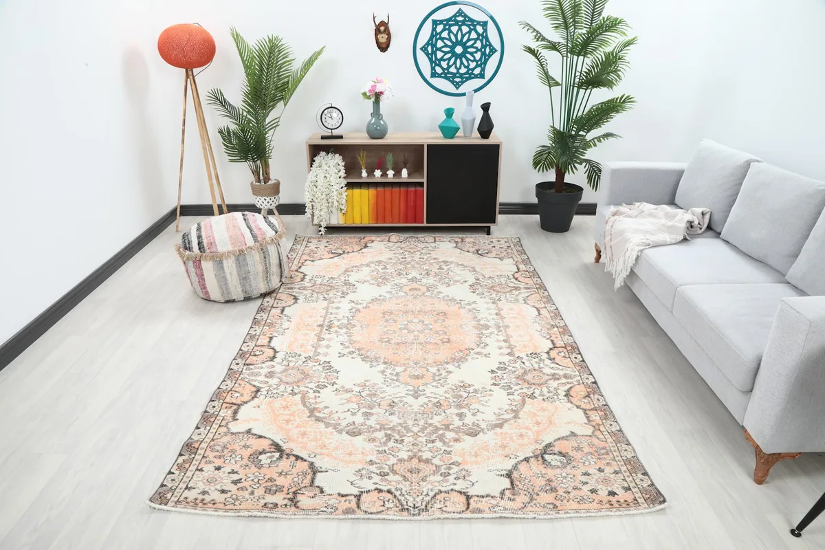 Vintage area rug in a modern living room setting, showing its scale and color
