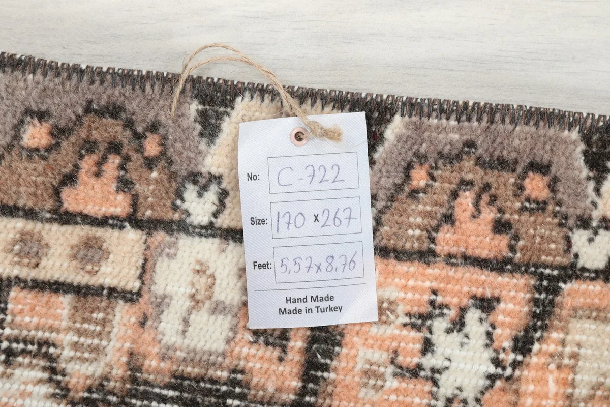 Product tag with rug dimensions and origin details attached to the rug's edge