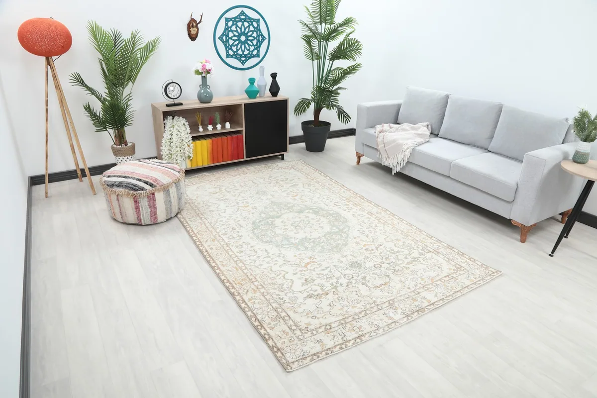 Angled view of the vintage rug in a living space, showing its size relative to furniture