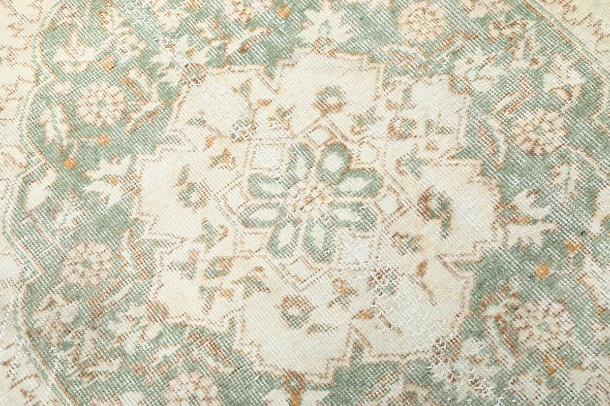 Close-up of the central green medallion with intricate floral designs