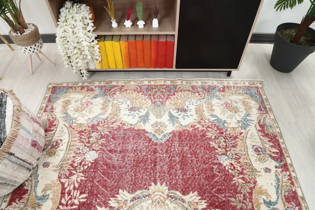 Angled view looking down at the rug's upper section, showing the floral details and colors.