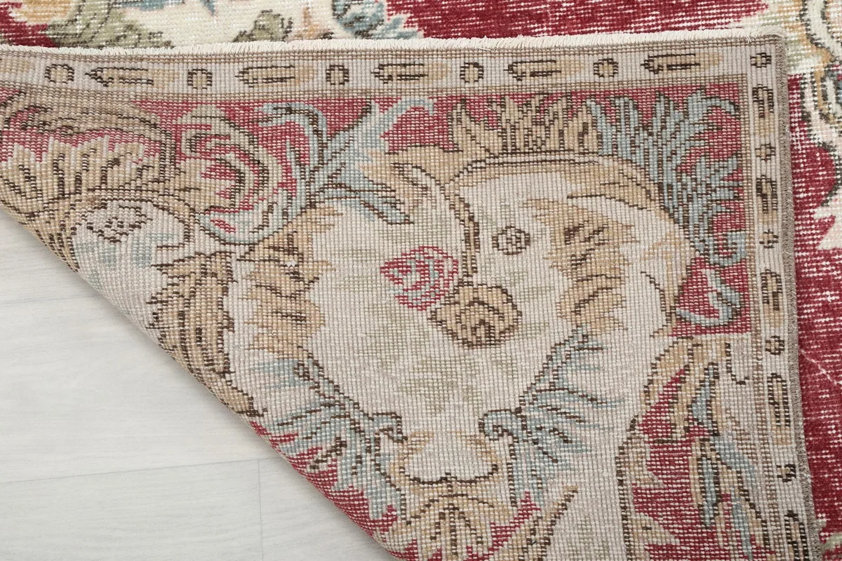 Close-up of the back of the rug, showing the knotting structure and a small section of the pile.