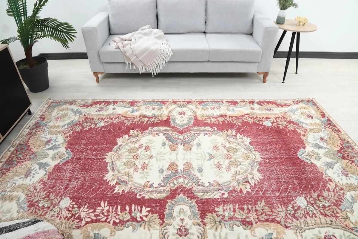 Overhead view of the rug in a living room, highlighting the central medallion and colors.