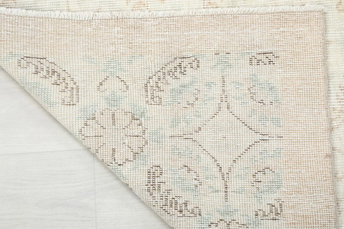 Close-up of the reverse side of the rug, showing the consistent hand-knotted pattern and cotton foundation.
