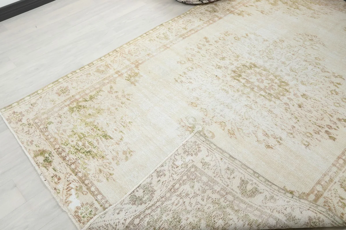 Corner of the rug folded back to reveal the back weaving and showing the overall design.