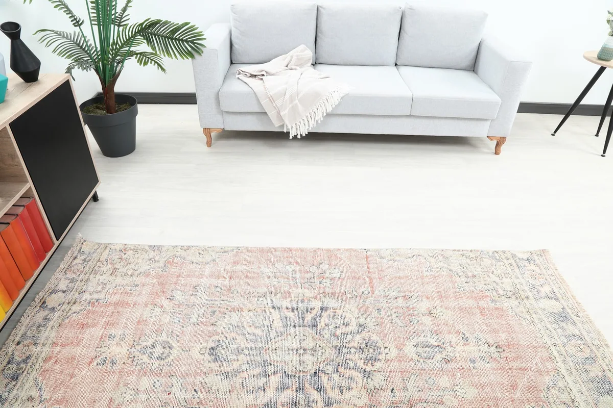 Overhead view of the runner in a room, positioned in front of a gray sofa, showcasing its pattern.