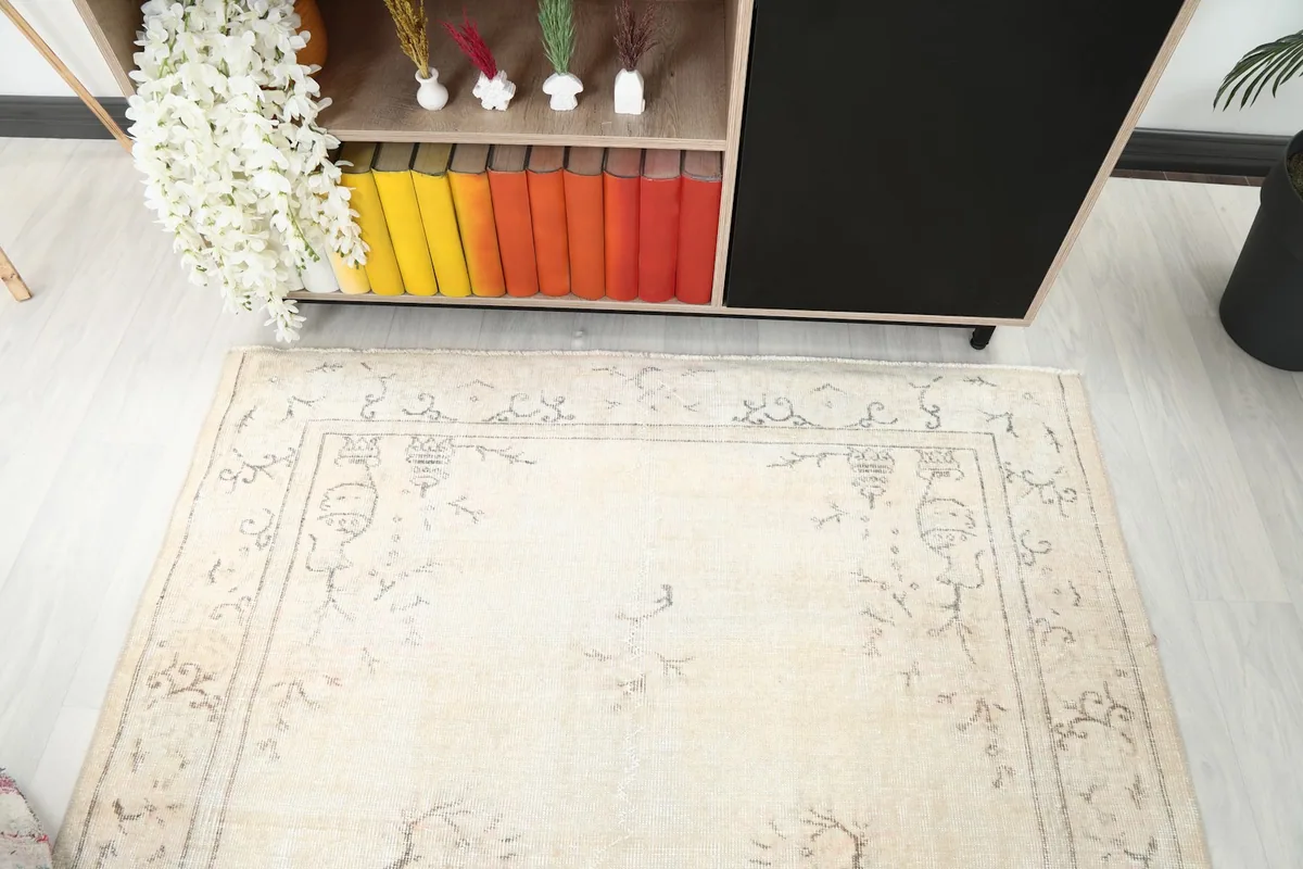 Angled view from above the rug, showing details of the design and interaction with room elements
