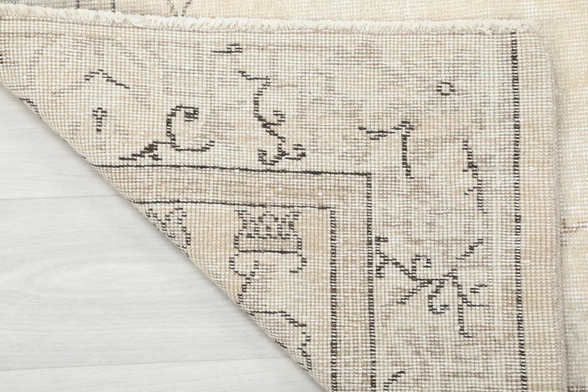 Underside view of the hand-knotted wool pile on cotton foundation, showing craftsmanship