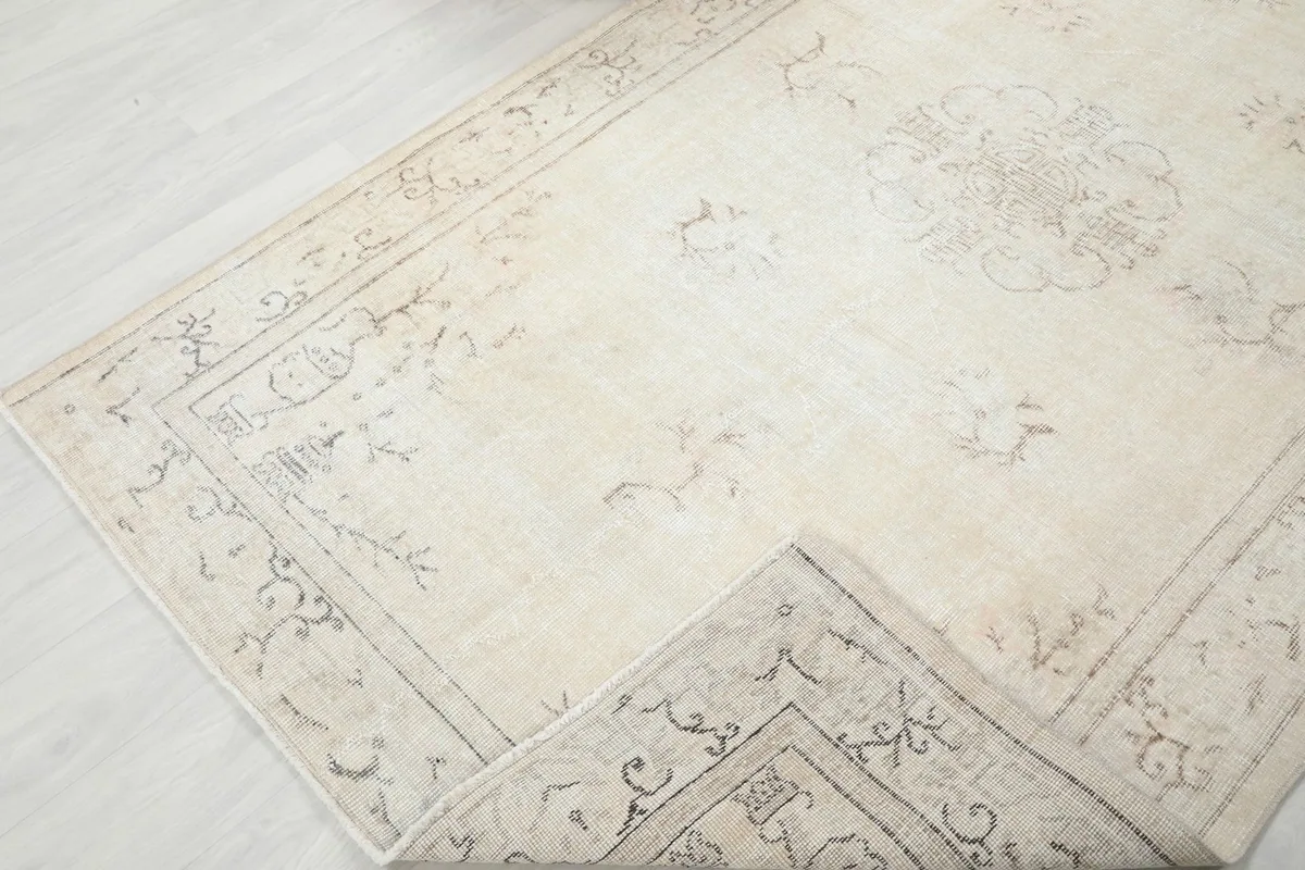 View of the rug folded to show the thickness and flexibility of the vintage wool pile