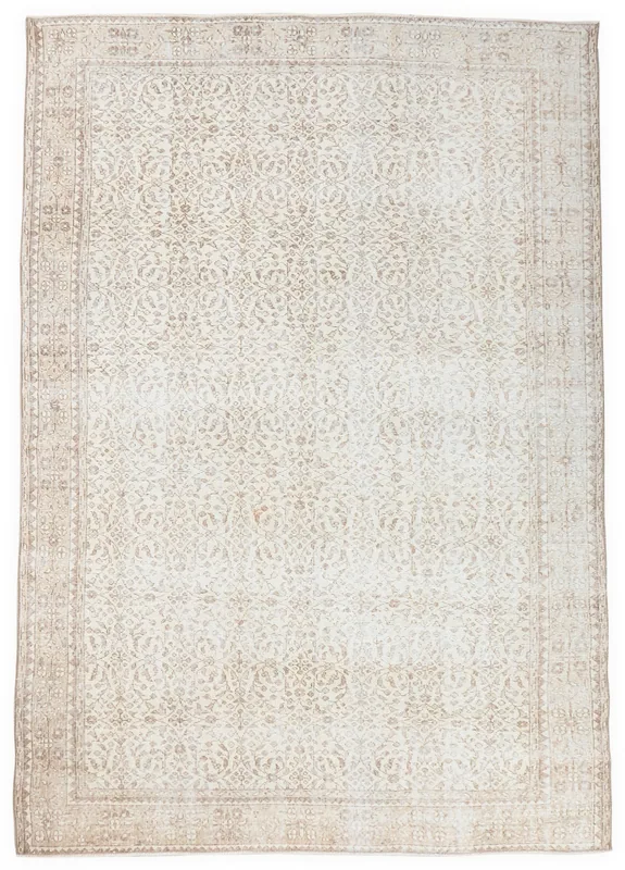 Full top view of the ivory and tan floral vintage Anatolian area rug on a white background.